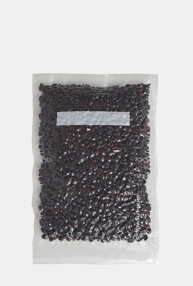 Clear and Clear 8 by 12 inch precut vacuum seal bag holding coffee beans on white background